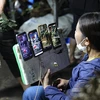 A seller livestreams at Tua Chua night market in Dien Bien province. The General Department of Taxation has asked local tax authorities to review and make lists of retailers selling through livestreaming to carry out risk-based inspections. (Photo: VNA)