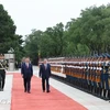 Lam and Xi pass an honour guard during a welcome ceremony for the former. (Photo: VNA)