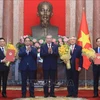 General Secretary of the Communist Party of Vietnam (CPV) Central Committee and State President To Lam (central) presents appointment decisions to three new Deputy Prime Ministers. (Photo: VNA)