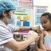 A kid gets measles jab at An Lac ward medical station in Binh Tan district. (Photo: VNA)