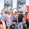 Foreign tourists are at Golden Bridge in Sun World Ba Na Hill tourist area in the central city of Da Nang. (Photo: VNA)