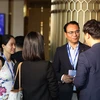 Representatives of companies discuss on the sideline of a forum about co-branded cards in Vietnam. (Photo Courtesy of Visa Vietnam)