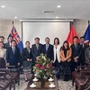 Representatives of the Vietnamese and Lao embassies in Australia pose for a group photo at the event. (Photo: VNA)