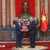 General Secretary of the Communist Party of Vietnam Central Committee and State President To Lam hands over an appointment decision to Vietnamese Ambassador to Laos Nguyen Minh Tam. (Photo: VNA)