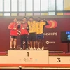 Tran Minh Tri of Vietnam (second left) takes two golds in the men's 67kg class at the World Youth Weightlifting Championships in Spain (Photo: VNA)