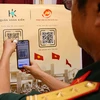 QR code scanning to enjoy the exhibition (Photo: VNA)