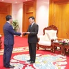 Vietnamese Ambassador to Laos Nguyen Minh Tam (left) presents his credentials to Lao Party General Secretary and President Thongloun Sisoulith on September 30. (Photo: VNA)