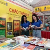 Visitors to an exhibition booth of the Thanh Nien Publishing House. (Photo: VNA)