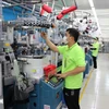 Labourers work in a Korean-invested factory. (Photo: VNA)