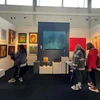 Visitors look at artworks by 13 Vietnamese painters at the Affordable Art Fair in London.(Photo: VNA)