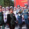 Vietnamese Minister of National Defence Gen. Phan Van Giang (left) and his Lao counterpart Gen. Chansamone Chanyalath inspect the guard of honour at the second Vietnam-Lao border defence friendship exchange on October 22. (Photo: VNA)