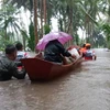 People are evacuated from flooded area in Albay province, the Philippines on October 22. (Photo: Xinhua/VNA)