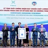 FIBAA General Director Diane Freiberger (third, right) hands over the certificate to the National Economics University (NEU) in Hanoi on October 24. (Photo: VNA)