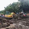 Rescuers conduct a search and rescue operation at the site of a landslide at a residential area in Batangas province, the Philippines, October 25 (Photo: XINHUA/VNA)