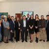 The Vietnamese Embassy delegation take a group photo with typical businesses in Central Mexico. (Photo: VNA)