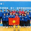 The Vietnamese delegation poses for a photo after winning the men's and women's singles titles at the World Shuttlecock Championships. (Photo: VNA)