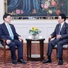 State President Luong Cuong (R) meets with Chief Executive of the Hong Kong Special Administrative Region (China) John Lee Ka-chiu in Lima on November 15 (local time) (Photo: VNA)