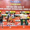 The Organising Board awards first and second prizes to outstanding athletes in the mixed doubles event. (Photo: VNA)