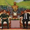 Minister of National Defence Phan Van Giang (left) meets with General Secretary of the Lao People’s Revolutionary Party and President of Laos Thongloun Sisoulith in Vientiane on November 19. (Photo: VNA)