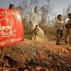 Children play near a landmine warning sign in the border area between Cambodia and Thailand. (Photo: AP)