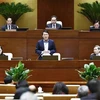 Minister of Public Security, General Luong Tam Quang (standing), delivers his report at the National Assembly's eighth session on November 26 (Photo: VNA)