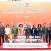 Participants at the opening of the photo exhibition in Hanoi on November 27. (Photo: VNA)