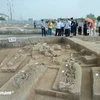 Researchers and media representatives visit excavation pits at Vuon Chuoi (Photo: VietnamPlus)