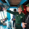 A representative from authority inspects the installation of vessel monitoring system (VMS) in a fishing vessel. (Photo: VNA)