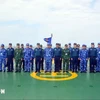 Coast guards of the two sides take a group photo at Vietnam’s Coast Guard Ships CSB 8004 (Photo: VNA)