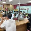 Customers deposit money at an Agribank branch in HCM City. (Photo: VNA)