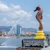 Tourists relax near Kampot province’s 8-metre-tall sea horse statue. (Photo: phnompenhpost.com)