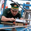 An officer checks a VMS device (Photo: VNA)