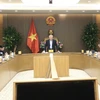 Deputy Prime Minister Nguyen Hoa Binh speaks at a meeting discussing the implementation of the Politburo's conclusion on building regional and international financial hubs (Photo: VNA)