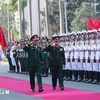 Defence Minister Phan Van Giang (left) and his Lao counterpart Khamliang Outhakaysone review the Guards of Honour on December 18 (Photo: VNA)