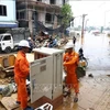 El personal de EVN repara un transformador inundado en la calle Chuong Duong Do, distrito de Hoan Kiem, Hanoi, antes de restablecer el suministro eléctrico. (Foto: VNA)