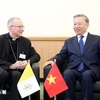 Le secrétaire général du Parti et président To Lam (droite) et le Premier ministre du Vatican, Cardinal Pietro Parolin.