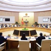 Prime Minister Pham Minh Chinh chairs the Government's monthly regular meeting on December 7. (Photo: VNA)