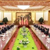 越南政府总理范明政会见中共中央总书记、国家主席习近平。图自越通社