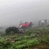 This grab taken from handout video footage released by Iranian Red Crescent Society (IRCS) on May 20, 2024 shows rescuers recovering bodies at the site of President Ebrahim Raeisi's helicopter crash in a fog-shrouded mountainous area of northwest Iran. (Photo: AFP/VNA) 