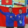 Pencak Silat athletes - Hoang Linh Dan (right) and Nguyen Thanh Long - win two gold medals in Seni events (performance) at the ongoing 13th ASEAN School Games (ASG) in the central city of Da Nang. (Photo: VNA)