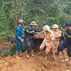 Rescuers find a victim after a mini bus is buried by a landslides in the mountainous province of Ha Giang on July 13. (Photo: VNA)