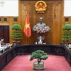 Prime Minister Pham Minh Chinh chairs a meeting on the monetary policy with leaders of the State Bank of Vietnam (SBV), the Ministry of Finance, the Ministry of Planning and Investment, and other ministries and agencies. (Photo: VNA)