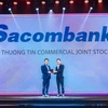 Nguyen Viet Trung, deputy director in charge of the Sacombank Human Resource Management Centre, receives the “Best Company to Work for in Asia” award given to the bank by HR Asia magazine. (Photo: Courtesy of Sacombank)