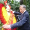 Party General Secretary and State President To Lam pays floral tribute to martyr Pham Hong Thai at his grave in the Huang Hua Gang Memorial Park. (Photo: VNA)