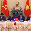 Representatives from the Ho Chi Minh National Academy of Politics, the Vietnam Academy of Social Sciences, the Lao National Academy of Politics and Public Administration, and the Lao National Institute of Economic and Social Sciences sign cooperation agreements on June 30, 2023. (Photo: VNA)