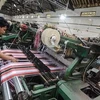 A worker completes production of sarong cloth in a textile factory in Majalaya industrial estate in Bandung regency, West Java. (Photo: Antara) 