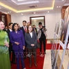 State Vice President Vo Thi Anh Xuan and Executive Vice President of Venezuela Delcy Rodriguez Gomez visit a photo exhibition about Vietnam-Venezuela ties. (Photo: VNA)