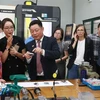 Parliamentary State Secretary to the Federal Ministry for Economic Cooperation and Development of Germany Bärbel Kofler ( first, left) is introduced to vocational training at LILAMA 2. (Photo: VNA)