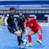 A Vietnamese futsal player (red) faces two Australian players at the semi-final match of the ASEAN Futsal Championship 2024 on November 8. (Photo: VNA)