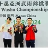 Nong Van Huu (left) poses with other medallists of the men's nanquan event at the Asian Wushu Championships on September 12 in Macau, China. (Photo of organisers)